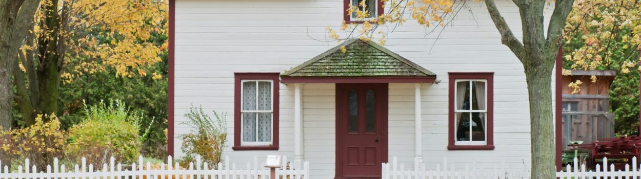 white house under maple trees