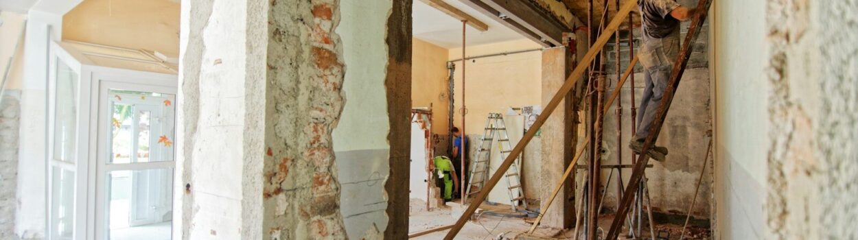 man climbing on ladder inside room